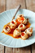 Herring rolls with onion and a spicy tomato sauce