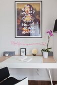 Mona Lisa with lettering motif above orchid on desk