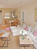 Dining table and sofa in natural shades in cosy interior