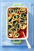 Pasta rolls with spinach and feta baked in tomato sauce