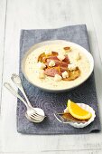 Creamy potato soup with duck breast, apple and croutons