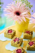 Vase of flowers and financier cakes on wedding buffet table