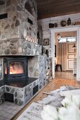 Stone-clad log-burning stove in living room