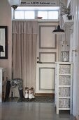 Panelled door with transom window in vintage-style foyer