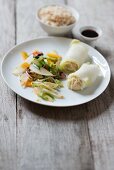 Filled Chinese cabbage rolls with wok vegetables