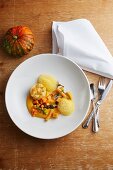 Assorted pumpkin dishes on a plate: pumpkin soufflé, pumpkin purée and pickled pumpkin