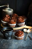 Chocolate cupcakes with rich chocolate frosting and a cup of coffee