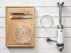 Kitchen utensils: a hand blender, citrus press, knife and peeler