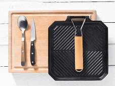 Kitchen utensils: grill pan, spoon and kitchen knife