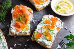 Bread topped with cream cheese, salmon, cucumber, radish and caviar