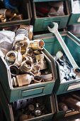 Various tools and lamp sockets in metal storage boxes