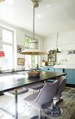 Lilac, retro upholstered chairs around dining table in vintage kitchen