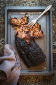 BBQ pulled pork being pulled apart with a fork (seen from above)