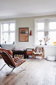 Old Scandinavian designer furniture in living room with wooden floor