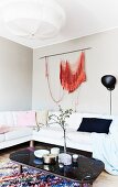 Orange wall-hanging in feminine lounge area
