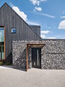 Modern house with dark wood and stone façade