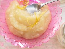 Apple sauce with strips of lemon peel and powdered sweetener