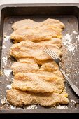 Chicken escalopes in breadcrumbs ready to be fried