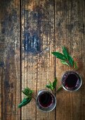Red wine and laurel leaves on a wooden background