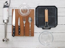 Various kitchen utensils: blender, cutlery, juicer and griddle