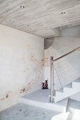 Concrete staircase with steel balustrade and concrete and brick walls