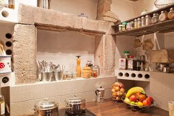 Niches above worktop in corner of rustic kitchen