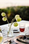 Glass of red wine and autumnal flower arrangement on table