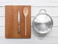 Knife, wooden spoon and saucepan