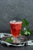 A beer cocktail with raspberries and scented pelargonium