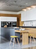 Kitchen counter and solid-wood table in open-plan kitchen