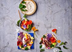Flatbreads with tuna, herbs, edible flowers and a dip