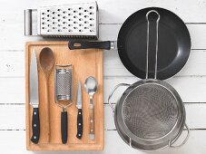 Kitchen utensils for the preparation of Spätzle (soft egg noodles from Swabia) with mushrooms and cheese