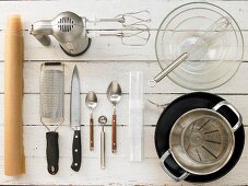 Kitchen utensils for making a melon and yoghurt cake with a biscuit base