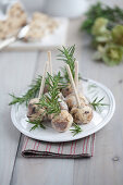 Stollen balls on wooden skewers with rosemary sprigs
