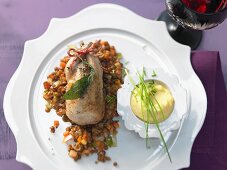 Braised quail on a bed of lentils with apple and leek