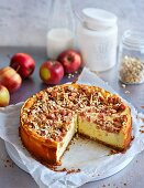 A vanilla quark cake with cranberries, apple and crunchy nut topping