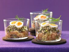 A salmon steak with lentils, quail eggs and honey mustard sauce