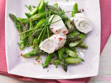 Turkey roulade on an asparagus salad with wasabi and pink pepper