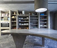 Béton brut in kitchen; dining table and shelves made from moulded concrete