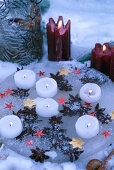 Candle tray made of ice with frozen star anise