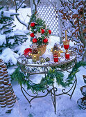 Decorated metal table at Christmas with Ilex (Holly)