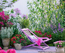 Terrace with deck chair by the flower bed