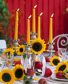 Table decoration in autumn with sunflowers and apples
