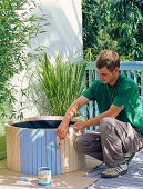 Covering the water plant bucket with wood