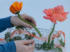 Table arrangement of silk poppy in wire mesh