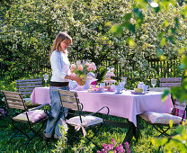 Table laid before blooming malus (apple tree)