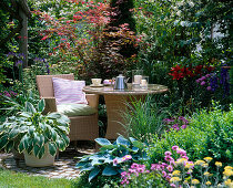 Small round terrace with wicker chair and table