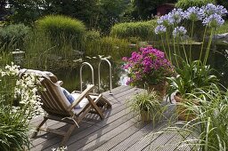 Wooden deck by swimming pond