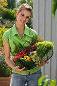 Woman with freshly bought organic vegetables in basket