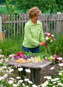 Tying colorful bouquet with peonies